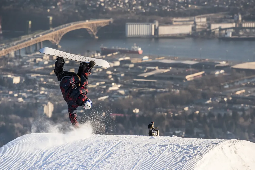 Scotty James knuckle hand drag over Vancouver for unCoked, with Anthill Films slow-motion camera. Photo: Jussi Grznar. Slopestyle snowboarding film production, Creative athlete-driven snowboard content, Red Bull branded action film crew, Snowboarding content for social media,